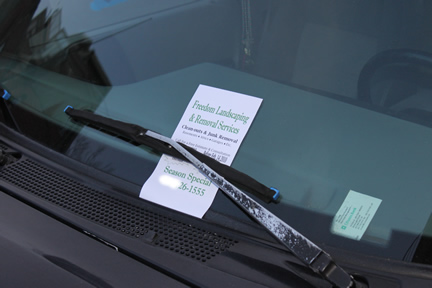 lawn care business flyer under windshield wiper