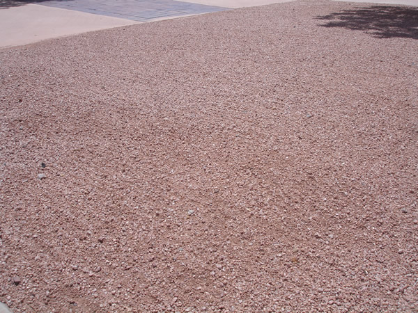 Lawn Care raking sand in Arizona